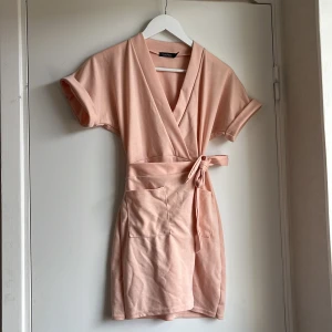 Omlott Klänning Stl:S - Denna sommar klänning passar till alla tillfällen! Den är lite mer åt se rosa hållet och har en underbar passform. Den är från BooHoo och är i så skönt material 😍