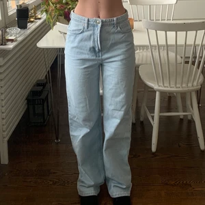 Jeans straight/wide mid-rise - Ljusblåa jeans från NA-KD. Lite nötta längst ner i benet, går att fixa för den händige. De är för långa på mig som är 167! Perfekta att sy upp :)