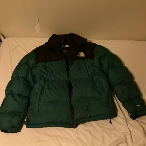 Grön North Face jacka - Jättefin grön north face jacka. Har inte använt den på över ett år nu. Har ett fåtal små skador men har tejpat för med grön tejp så man ser verkligen ingenting av det.