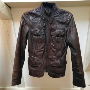 Vintage Kenneth Cole Leather Jacket - Moto Style Slim Fit 4 Button Pockets Metal Branding Buttons Zip Detail on Cuffs for Comfort  Best Fits Size XS 