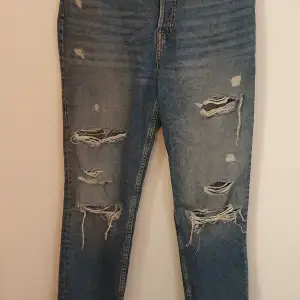 Ett par ripped jeans från H&M med knappgylf, använda några få gånger men inget som märks