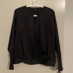 Svart blus  - Svart blus med omlott urringning, 