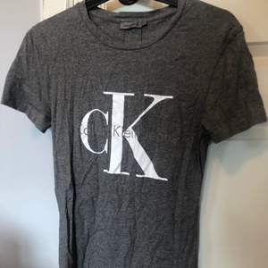 Grå t-shirt från Calvin Klein, knappts använd. Skriv för fler bilder! 