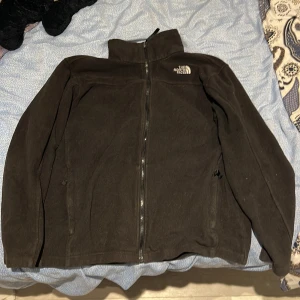 North Face Fleece - Svart North Face fleece i passform S (18/20). Aldrig bärt den då den är för liten för mig. Har du en fråga så går det bra att ställa så svarar jag asap. kan tänka mig sänka priset vid snabb affär