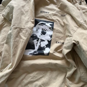 Beige jeansjacka - Beige jeansjacka med en bild på baksidan. Aldrig använd. Säljer pågrund av att den är för liten för mig