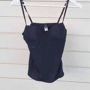 Black Top - Flexible black top with built in bra, very comfortable but it doesnt fit my style anymore. In good condition.
