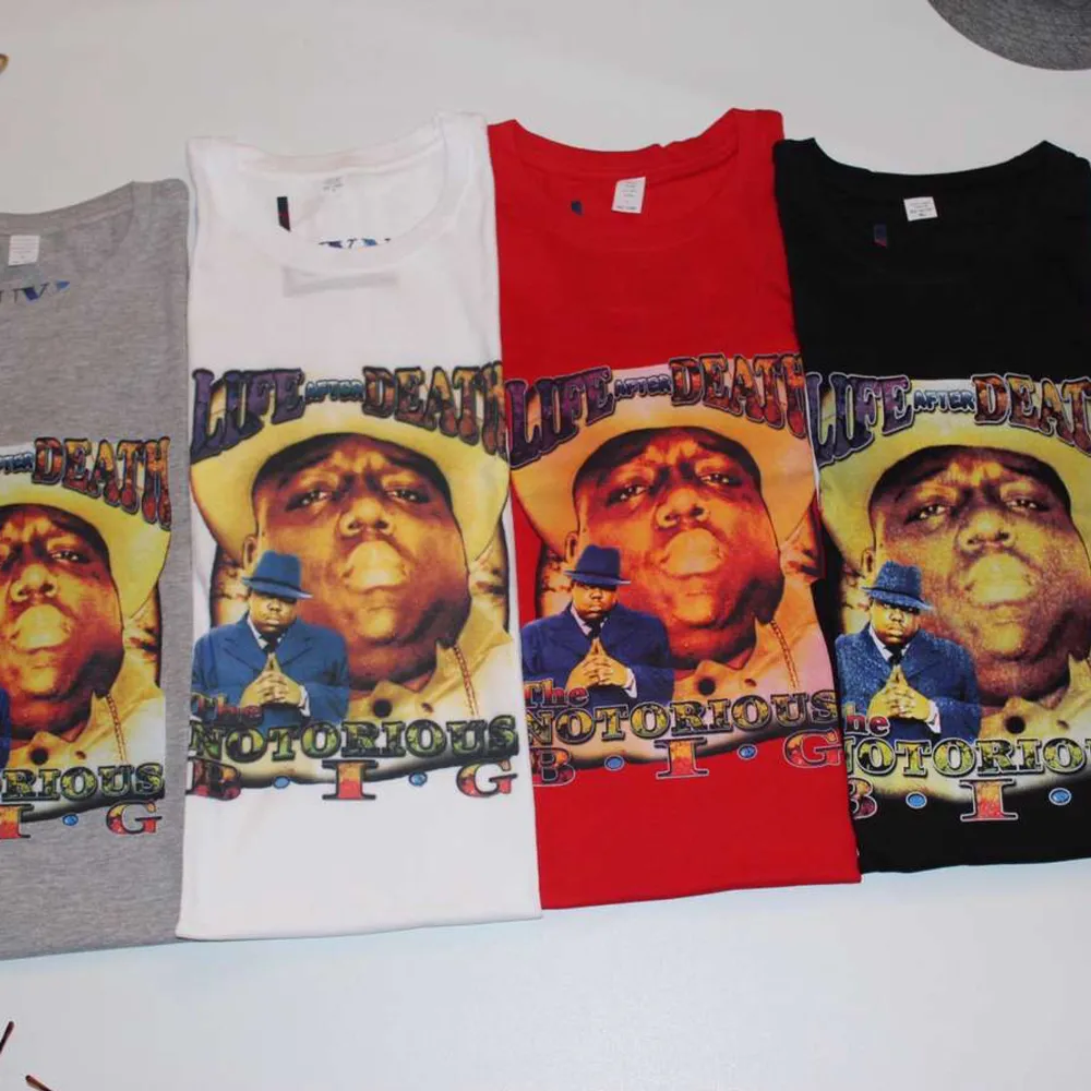 Gör dig redo för dessa snygga Notorious B.I.G T-shirts. Unisexdesignen gör den lämplig för både tjejer och killar och det mjuka bomullsmaterialet ger en bekväm känsla hela dagen. VIT- St L GRÅ -St M  RÖD - St L  Svart - St L. T-shirts.