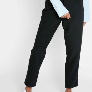 Kostym byxa i mjuk material  - Kostymbyxa i högmidjade model. Slutsålda överrallt, tygskärp som kan användas med eller utan