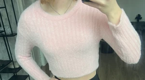 Rosa stickad tröja - Väldigt kort så skulle säga Crop top fast tröja. Den är väldigt väldigt skön å mjuk. Frakten kostar 45/60kr.  Storleken är 152/ Xs