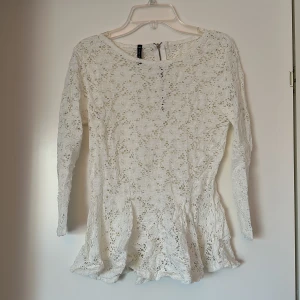 Spetstopp - Spetstopp i vitt med trekvarstsärm.  Dragkedjedetalj bak.  Stretchig. 