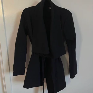 Svart kappa - Svart kappa med skärp i midjan  Storlek XS 