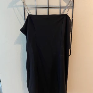 Svart klänning  - Svart jättefin klänning med strassband och en liten slits på frsmsidan vid låret typ. Aldrig använd då jag inte använder klänningar😂🫶🏽