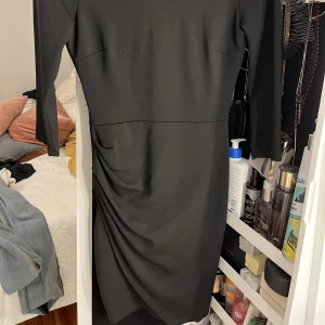 Klänning  - Svart aftonklänning med en liten öppen rygg. 