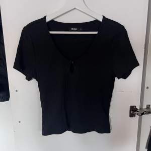 En svart ribbad T-shirt från Bikbok i storlek L. Använd ett fåtal gånger, fint skick.