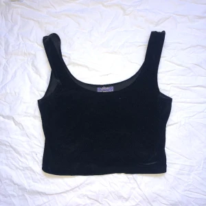 SVART SAMMETS TOPP - Svart tanktop med en velour material. Sitter precis över naveln för mig så är högmidjad. Super mysig! Rekommenderar starkt! Köpt secondhand i Berlin! Osäker på storlek men passar mig som är S-M i storlek i toppar