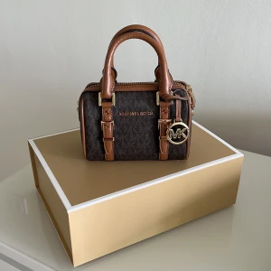 Michael Kors Extra-Small Logo Duffle Crossbody Bag - Michael Kors Handväska Bedford Leagcy 32F9G06C0B i Brown/Acorn. Väskan är i helt nytt skick då aldrig använt!  