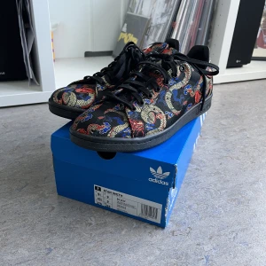 Adidas Stan Smith - Dragon Print - Intressekoll, pris kan diskuteras.  Adidas Stan Smith - Dragon Print EH2237 Storlek 43 1/3 EU Nyskick, oanvända i originallåda. Originaltaggen är avklippt pga de var på showcase.   Pris på StockX: $677 Senast sålda på StockX: $205  Dm för bilder o pris