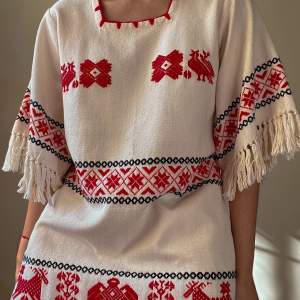 Vintage Mexican Boho Dress With Red/Black Embroidered Details And Fringe Sleeves And Hem. 2 Hip Pockets  Very Good Condition.  Best Fits M/L150 CM/ 59.1 IN Long 35 CM/ 13.8 IN Sleeve 39 CM/ 15.4 IN Shoulders 96 CM/ 37.8 IN Chest 96 CM/ 37.8 IN Waist