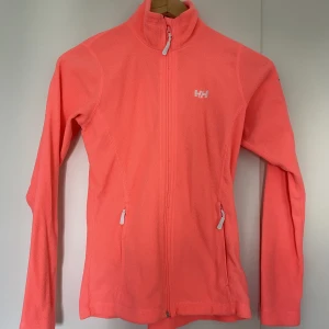 Fleece jacka - Fleece jacka i neon orange färg med fragkedje fickor