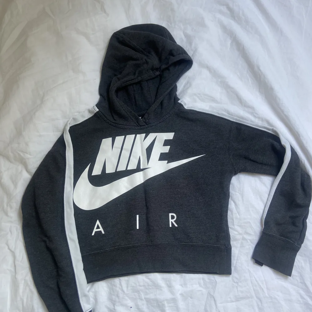 Mörkgrå Nike hoodie (magtröja? Vit text på framsidan o ingen text på baksidan. Vit sträck på ovansidan av armarna. Köpt för 400.. Hoodies.
