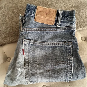 LEVIS 501 VINTAGE  - Säljer mormors Levis från 70-talet, 501:or.  Svårt att se storlek men jag har storlek M på byxor och 27-28 tum på jeans och dessa sitter bra på mig!   Jag är 159 cm lång!  Det finns en fläck framtill, går säkert att bort i tvätten🫶🏻  500 kr + frakt