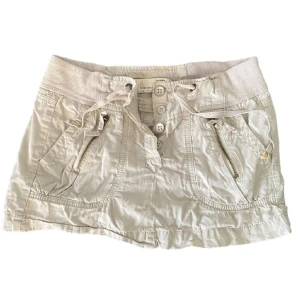 Cargo kjol - PRIS KAN DISKUTERAS Midjemått 38 cm. Vintage cargo miniskirt från ”gamla” bershka. beige färg. Storlek 34/xs, kan passa en liten S. Superfin verkligen! Perfekta sommarkjolen y2k 