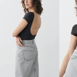 Topp med öppen rygg  - Supersnygg mörkgrå topp med öppen rygg från Gina tricot, använd 1 gång. Kan gå ner i pris 