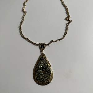 Gold necklace with green stones. 