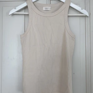 Sandfärgat linne - Enkelt linne från Gina Tricot som endast använts ett fåtal gånger. Storlek S, men skulle absolut kunna passa fler🥰