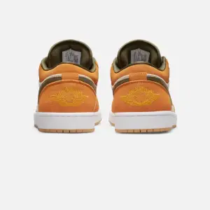 Air Jordan 1 Low Orange Olive  The Air Jordan 1 Low SE ‘Ceramic’ applies refined earth tones to a low-profile silhouette modeled after the 1985 original. The upper combines an off-white canvas base with orange suede overlays and an olive green suede Swoos