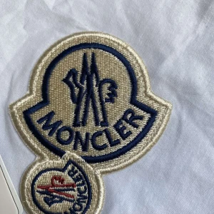 Dubble- patch Mincler T-shirt - Vit dubble-patch Mocler T-shirt i storlek M till salu. Den har lappen kvar och NFC skannen finns på lohon. Den är i nyskick. Tvivlar inte att ställa frågor.