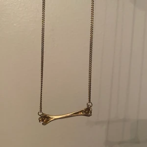 Halsband Maria Nilsdotter - Guldit halsband från Maria Nilsdotter med ett guldit ben.