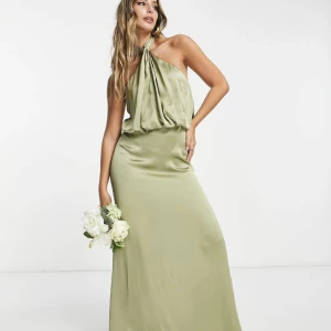 Olivgrön satinklänning - En olivgrön satinklänning som är ryggklappning med halterneck. Använd endast 1 gång. Nypris 1250kr säljes för 700kr 