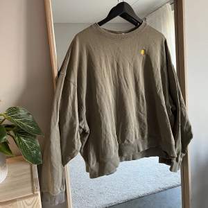 Sweatshirt från Weekday i en fin khaki/militärgrön färg. Fin detalj av en sol på framsidan av bröstet. Sparsamt använd och i princip nyskick. Noppor i tyget men varit så sedan inköp.  