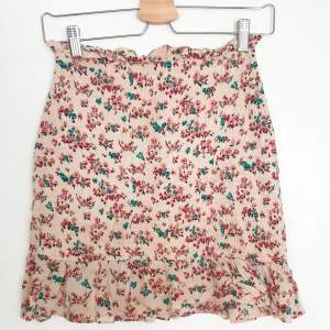 Comfy Mini Skirt with frills in a pink/green floral pattern  Size: s, but it is extremely stretchy so it would fit an m without doubt  Used although in great condition.