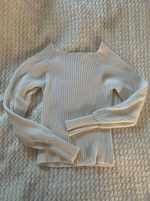 Vit ribbad stickad tröja från SHEIN - Säljer en vit ribbstickad tröja från SHEIN med långa ärmar och rund hals. Tröjan har en tight passform och är gjord i ett mjukt, stretchigt material som passar perfekt till många olika outfits.