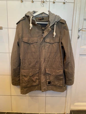 Vintage Indicode fieldjacket - Säljer en olivgrön fieldjacket från Indicode med grå huva som inte säljs längre😁         Strl: M      Pris:249kr    Skriv privat vid minsta fundering🤩