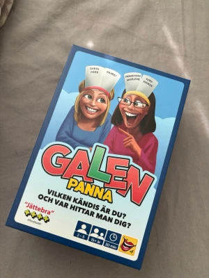 Galen Panna sällskapsspel - Galen Panna är ett roligt sällskapsspel där du gissar vilken kändis du är genom ledtrådar från andra spelare. Spelet innehåller färgglada kort, snurrhjul, elastiska pannband och en timglas. Perfekt för spelkvällar med vänner eller familj. Original pris 289kr