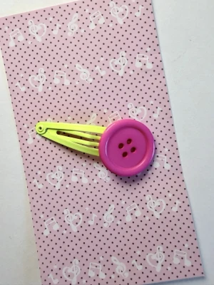 Hårklämma med knappar gul rosa - Handgjord hårklämma med knappar i gul och rosa🍀finns liknande på min profil. Kommer med gåvor😇