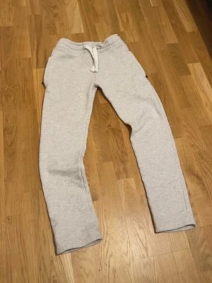 Ljusgrå mjukisbyxor från Russemerch - Säljer ett par ljusgrå mjukisbyxor från russemerch  i storlek XXS. Byxorna har dragsko i midjan och är tillverkade i mjukt, skönt material med borstad insida. Perfekta för chill dagar hemma eller när du vill vara extra bekväm.