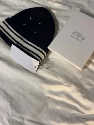 Maison Margiella mössa - Super snygg mössa från Maison Margiella! Kommer i original förpackning med tag på🍾Kan gå lägre vid smidig affär🫱🏻‍🫲🏼