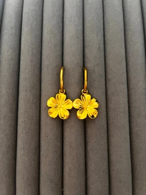 Guldpläterade blomörhängen - Snygga örhängen i guldpläterad metall med hängande blommor i fyrklöverform. Blommorna har fina detaljerade blad och örhängena har enkel klickstängning. Perfekta för dig som gillar blommiga accessoarer med guldfinish.