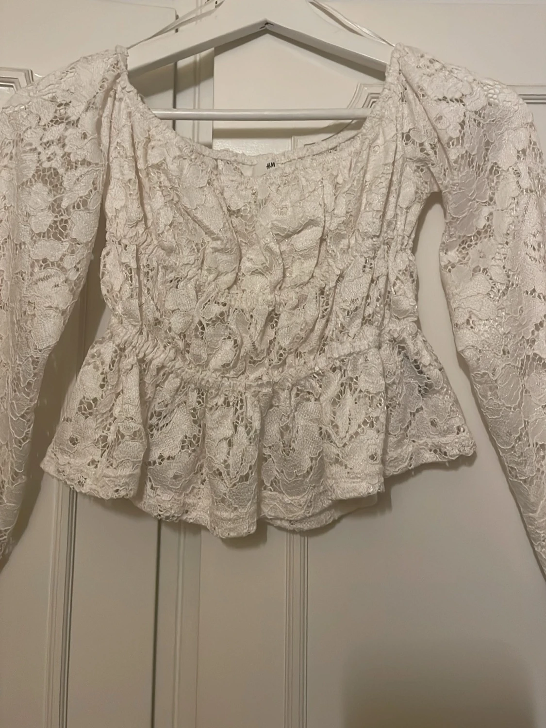 Vit spetsblus med volang från H&M