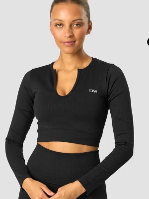 Svart långärmad crop top från ICANIWILL - Svart ribbad långärmad crop top från ICANIWILL med en snygg v-ringning och liten logga på bröstet. Tight passform och stretchigt material som passar perfekt till träning eller gym. Enkel och stilren design.