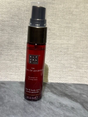 Ny! Rituals The Ritual of Ayurveda mist - Ny! Body mist 20ml. En lyxig hår- och kroppsmist från Rituals i serien The Ritual of Ayurveda. Flaskan är mörkröd med svart spraymunstycke och genomskinligt lock. Doften innehåller inslag av ros och söt mandel. Perfekt att spraya både i håret och på kroppen.