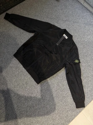 Stone island black jacket/windbreaker - Size M, true to size. Brand new and never worn, very comfortable and great quality.