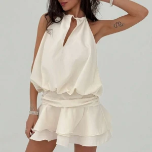 Vit halterneck klänning med volang - En superfin halterneck klänning i gräddvit nyans. Skön och perfekt klänning men var tyvärr för liten för mig. Aldrig använd och nypris är 219 kr. 