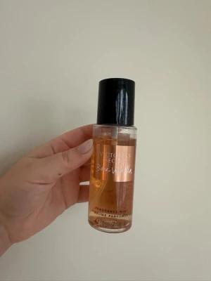 Victoria's Secret Bare Vanilla mist - Parfymmist från Victoria's Secret i doften Bare Vanilla. Flaskan är genomskinlig med kopparfärgad etikett och svart plastlock. Innehåller 75 ml och har en söt, varm vaniljdoft med inslag av mjuk kashmir.