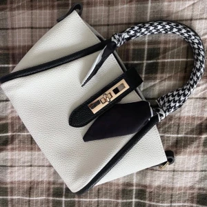 Vit och svart handväska med scarfdetalj - Mindre svart/vit väska! Kommer med ett lång band! Använd 2 gånger! Man kan ta bort scarfdetaljen Höjd: 15cm längd: 20cm