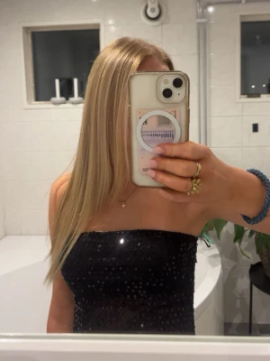 Glittrig tub topp - Jättesnygg svart topp med pajätter! Den har en lite slit på sidan och tjockare material upptill. Aldrig använt bara testat på!